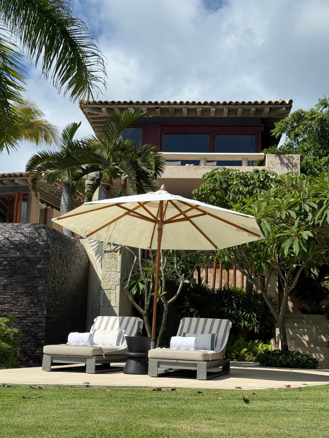 Front view of Casa Roka Punta Mita with lounge chairs and umbrella